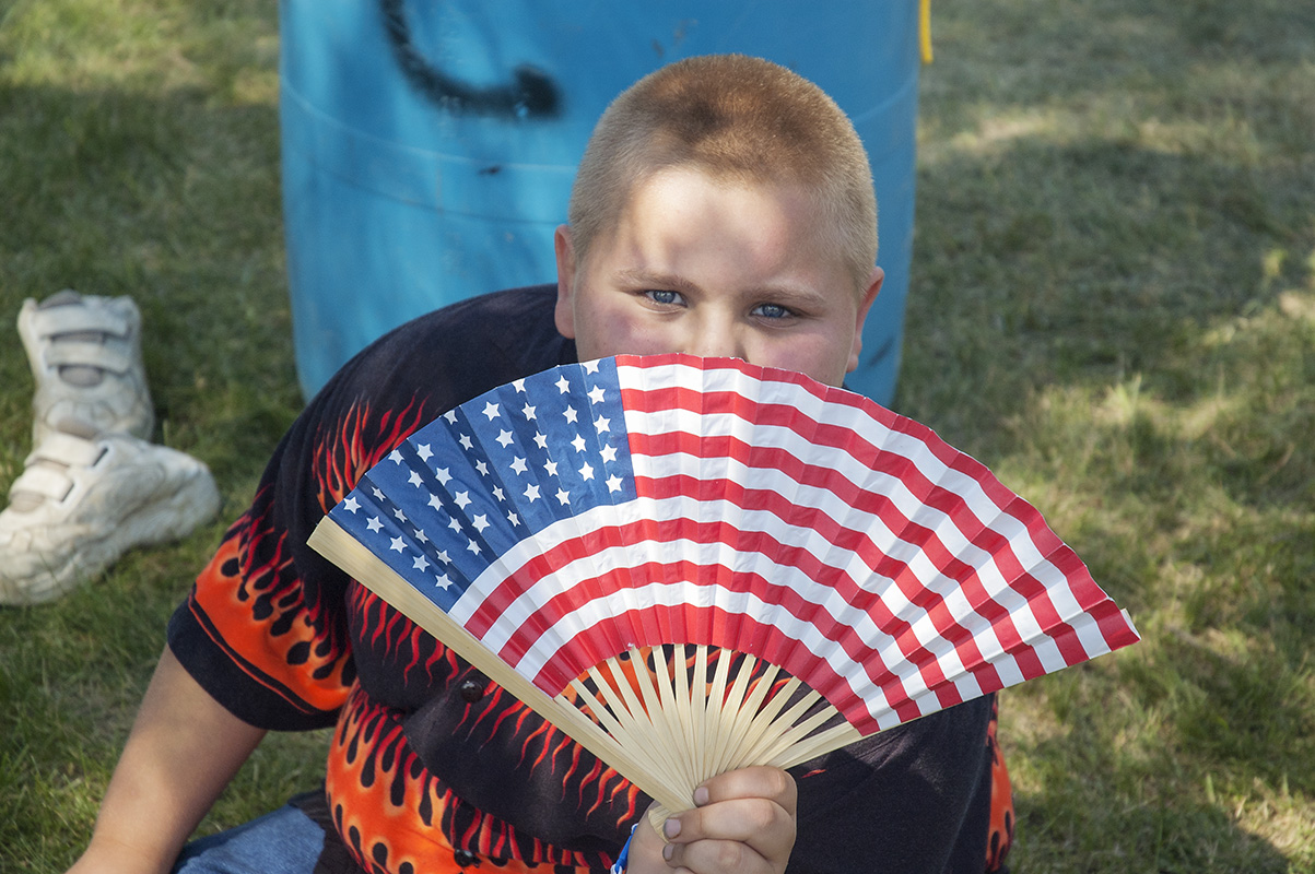 Boy with a patriotic fan, Victory City Festival, Kingsford Heights IN, 2005